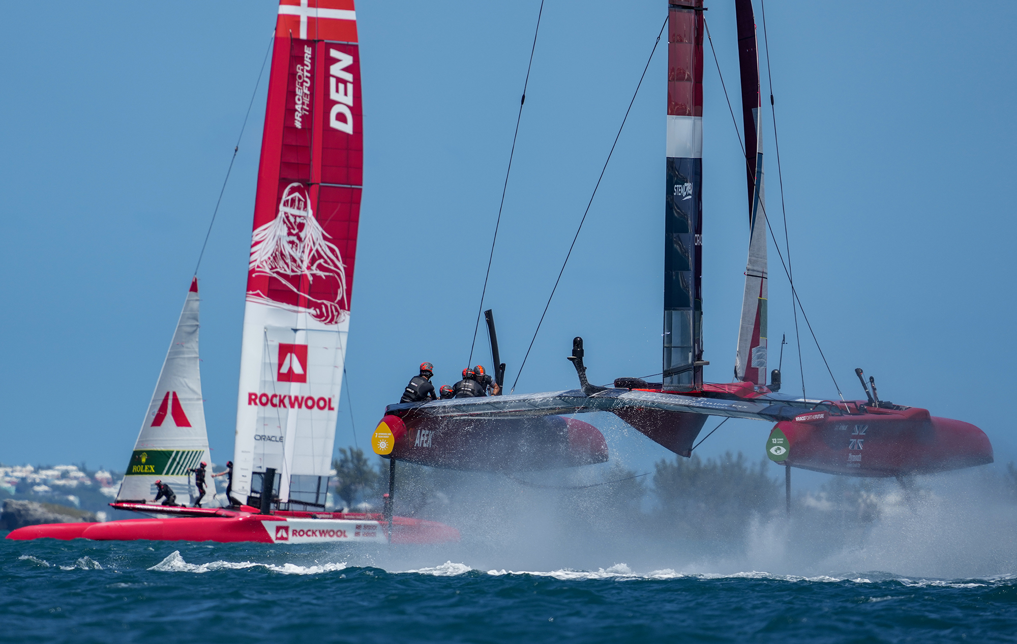 SailGP F50 catamarans foiling out of the water