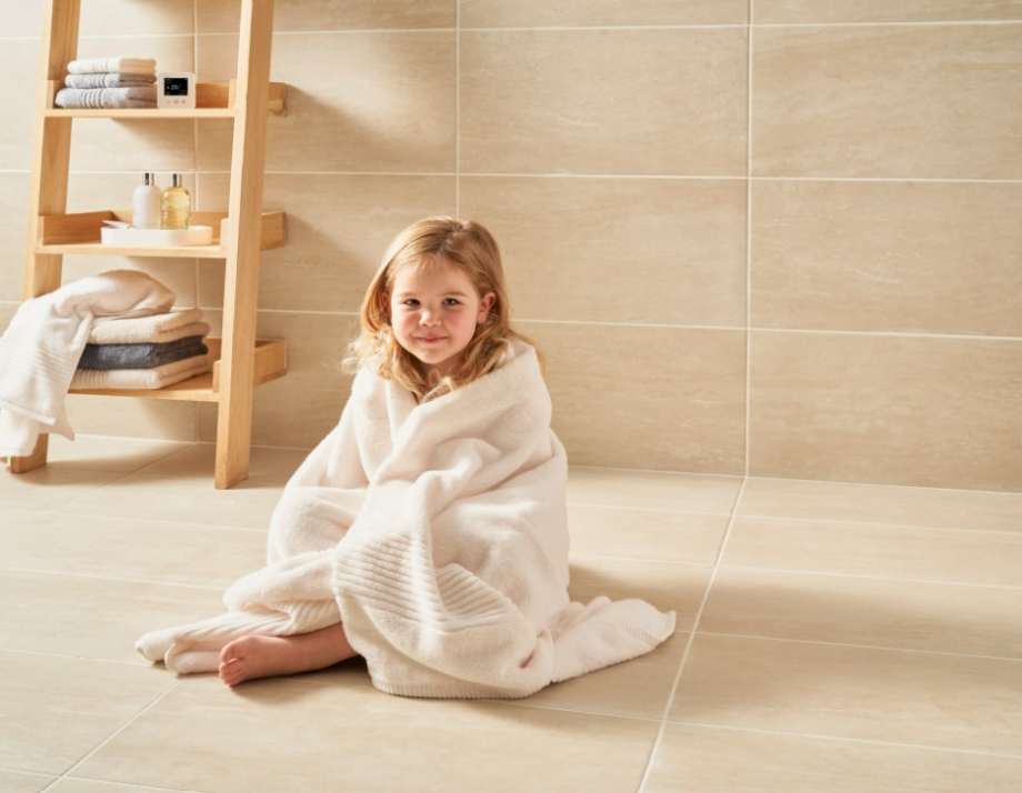 Child sitting on heated floor