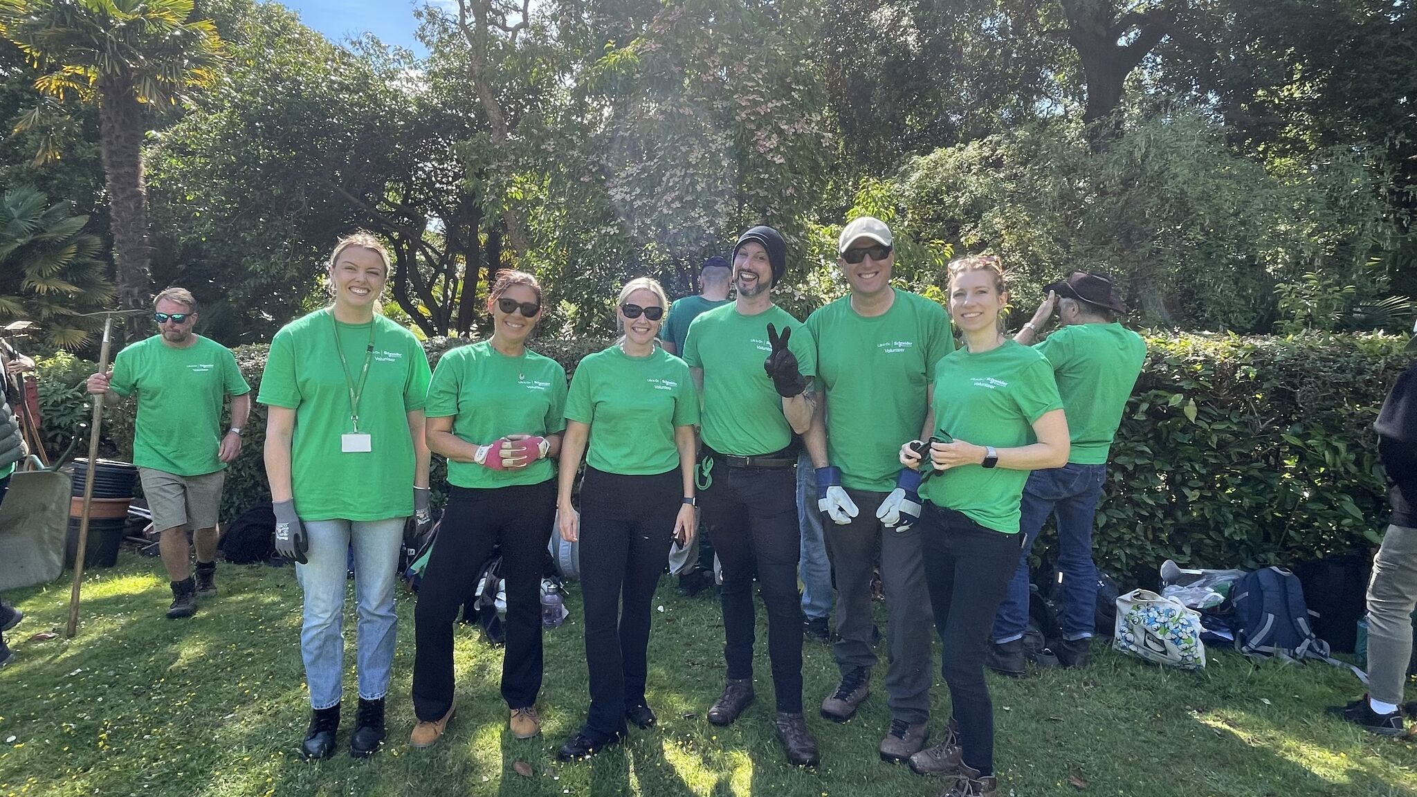 Drayton's volunteering day team memebers smiling for the camera at Mount Edgcumbe, Cornwall